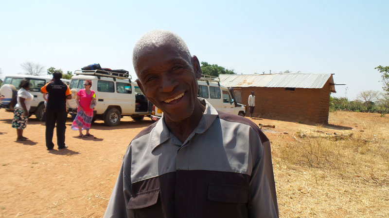 Bee farmer from Tanzania smiles at the camera.