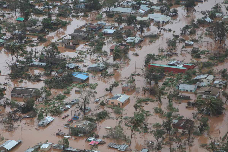 Aerial view of Sofala in Mozambique shows houses submerged in brown flood water.