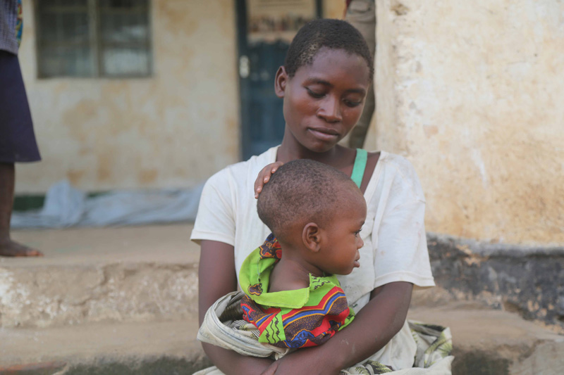 A mother holds her baby in the aftermath of Cyclone Idai in Malawi.