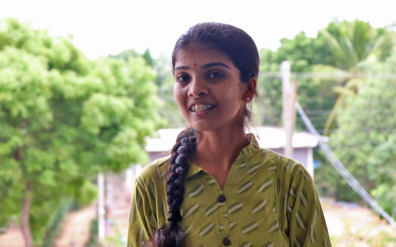 a young SriLanka woman smiles at the camera