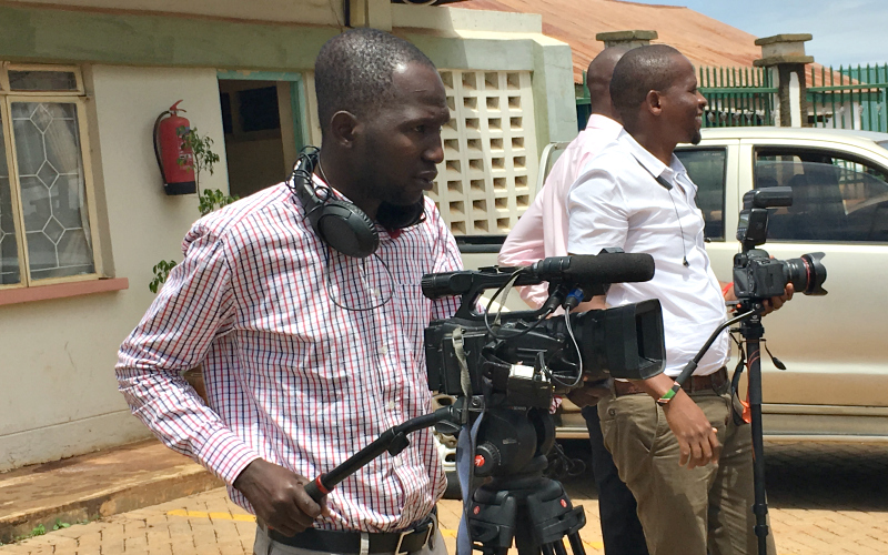 A man operates a video camera